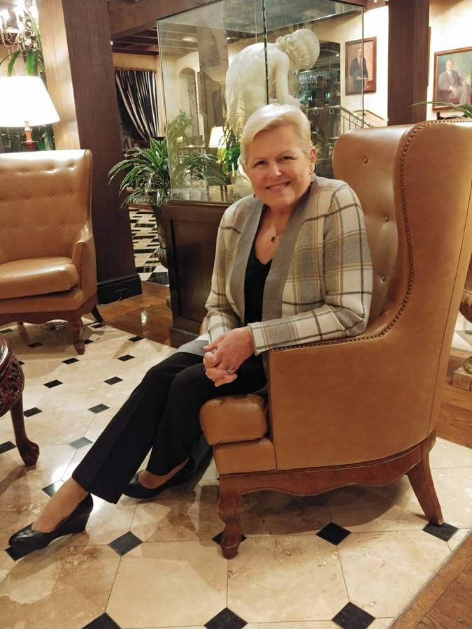 Shannon smiling in a leather armchair