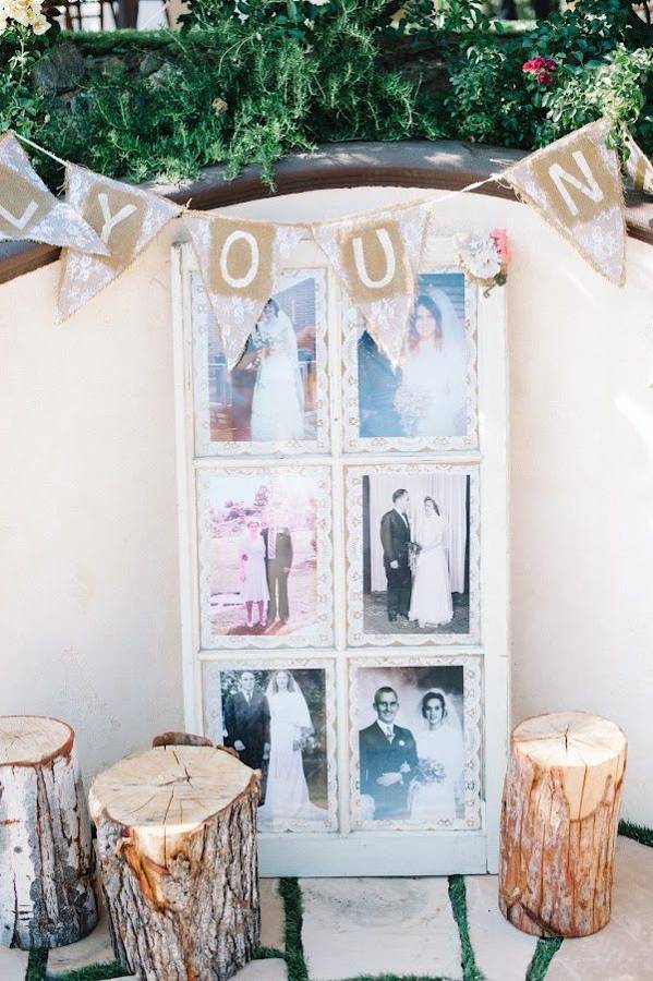 Framed vintage wedding photos of family on a window frame decorated with bunting