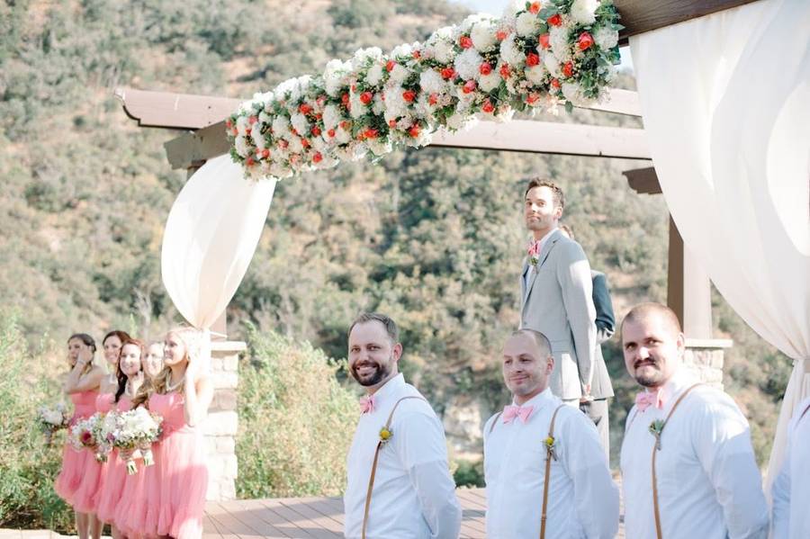 Groomsmen and bridesmaids watching as the bride arrives