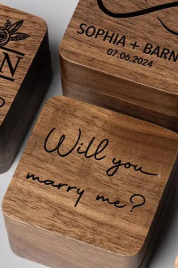 Walnut ring boxes, one engraved “Will you marry me?”